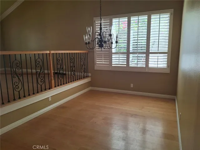a view of a room with wooden floor and windows
