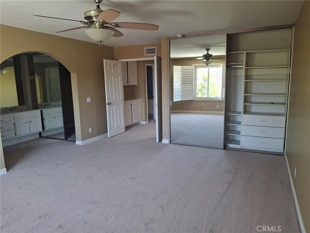 a view of empty room with ceiling fan