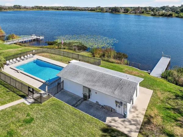 an aerial view of a house with a yard swimming pool and outdoor seating