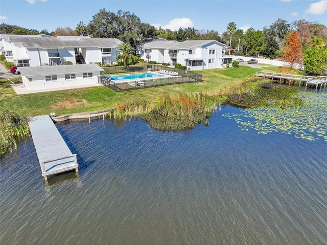 an aerial view of a house with swimming pool patio and outdoor seating
