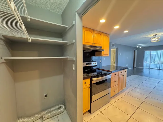 a kitchen with stainless steel appliances granite countertop a stove and a refrigerator