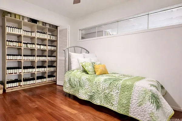 a bed sitting in a bedroom next to a large window