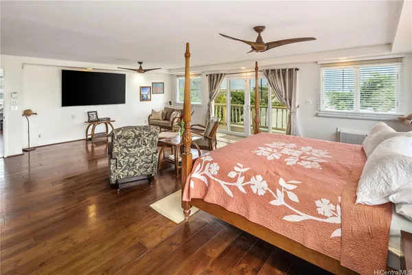 a spacious bedroom with a bed and a flat screen tv