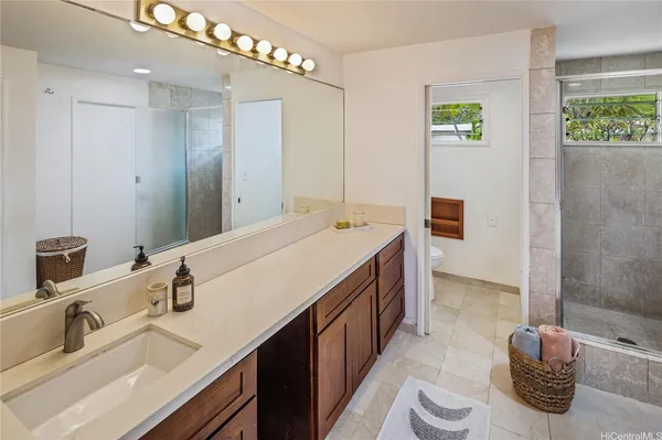 a spacious bathroom with a double vanity sink and a mirror