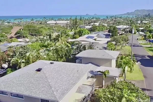 an aerial view of a house with a yard and lake view