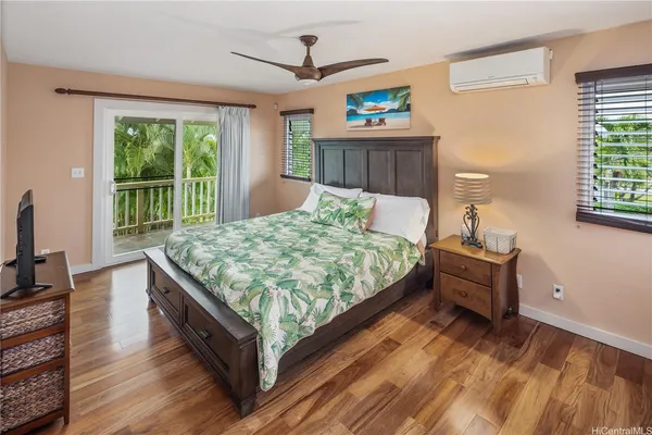 a bedroom with a bed and a dresser next to a window