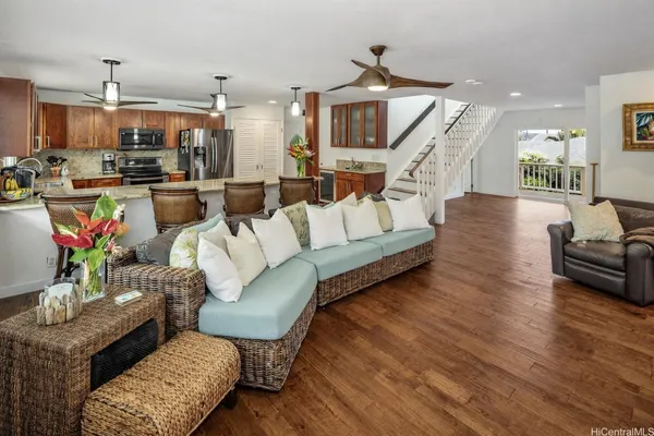 a living room with furniture and kitchen view