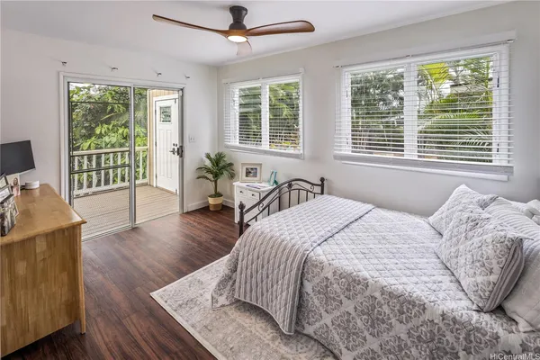 a spacious bedroom with a bed and wooden floor