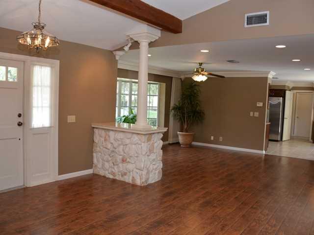 101 South River Road Stuart, FL 34996 - Photo 13 of 22 an empty room with wooden floor and windows