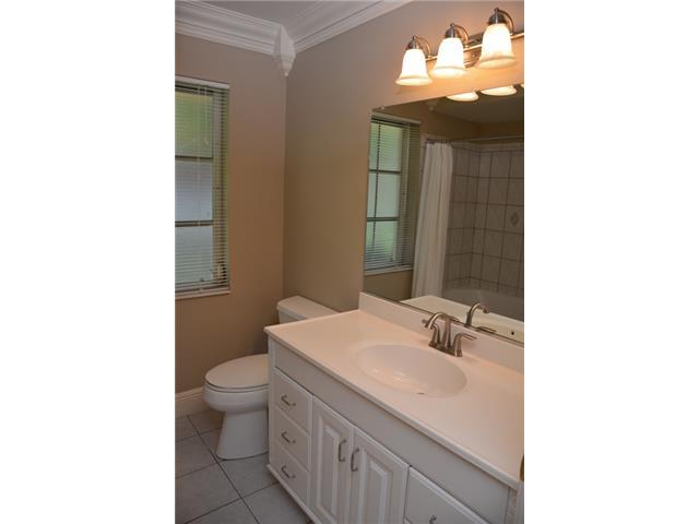 101 South River Road Stuart, FL 34996 - Photo 18 of 22 a bathroom with a sink and a mirror