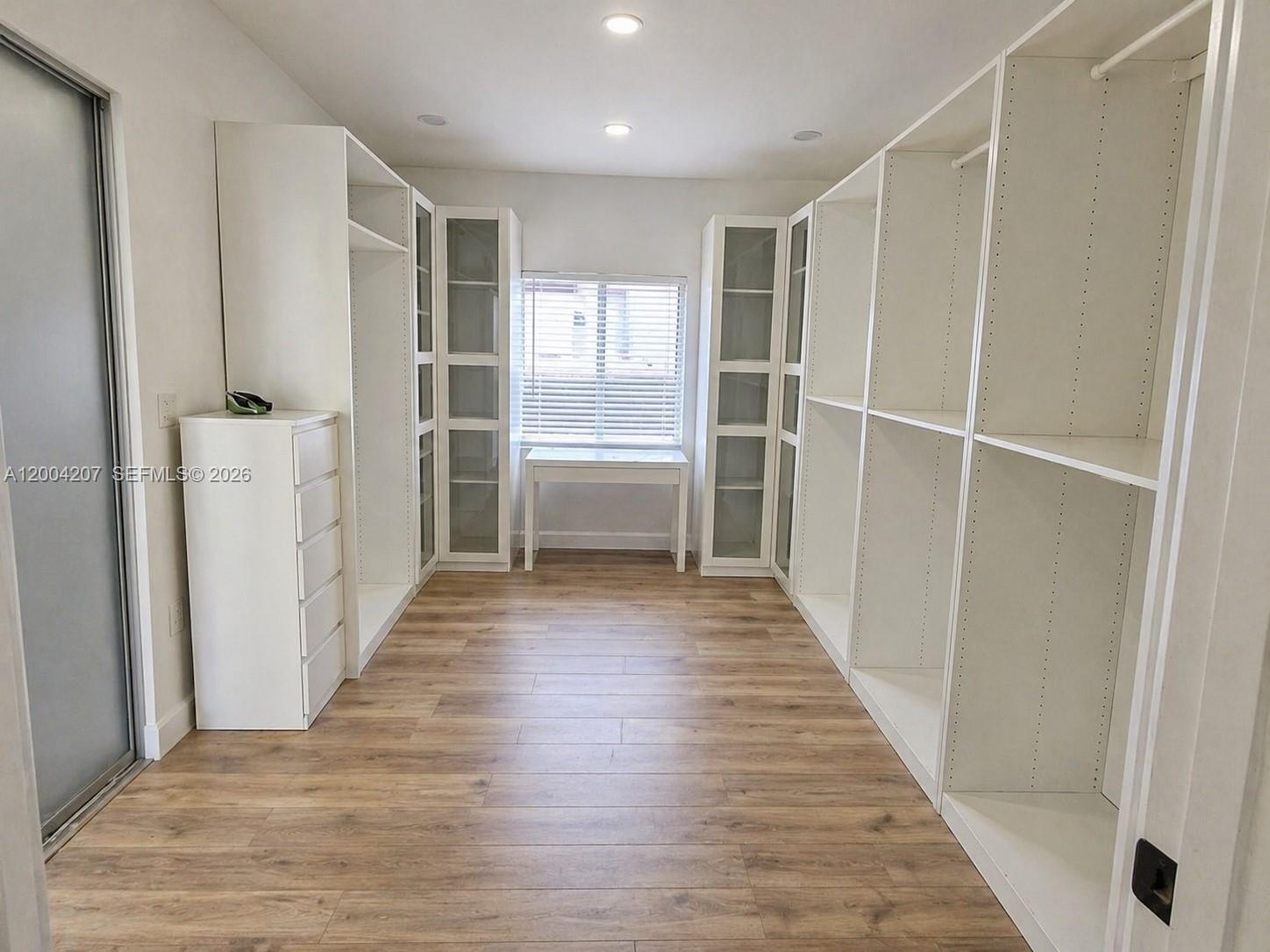 426 Southwest 26th Road Miami, FL 33129 - Photo 9 of 9 a view of walk in closet with wooden floor and entryway