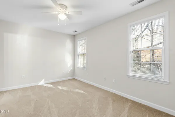 an empty room with windows and closet