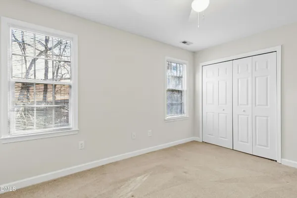 an empty room with a ceiling fan