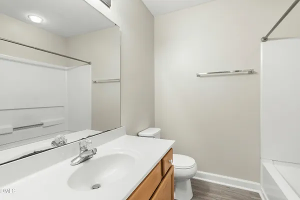 an empty room with closet and a chandelier fan