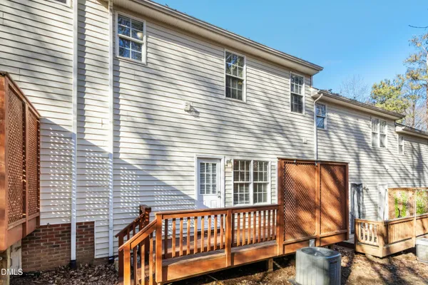 a view of a house with wooden fence