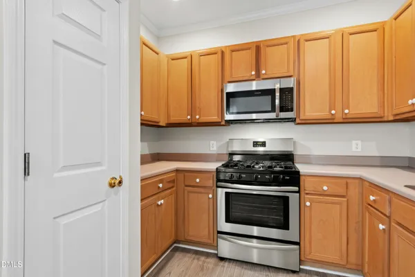 a kitchen with granite countertop white cabinets and stainless steel appliances