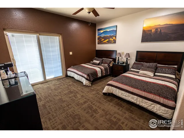 a bedroom with bed and a flat screen tv