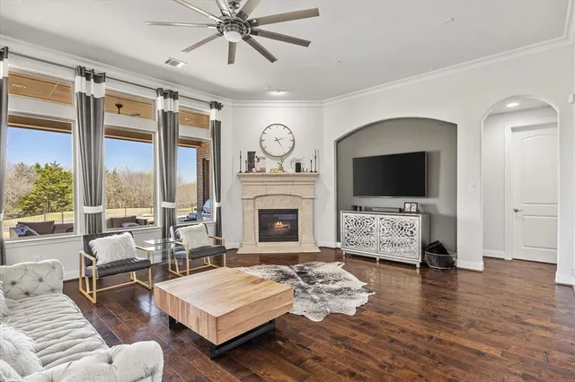 a living room with furniture a fireplace and a flat screen tv