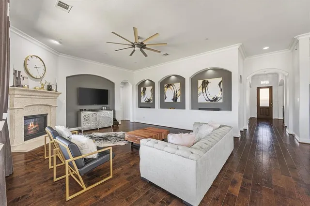 a living room with furniture a fireplace and wooden floor