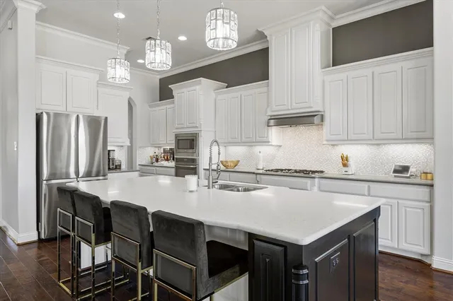 a kitchen with refrigerator cabinets dining table and chairs
