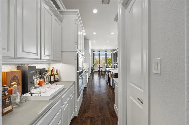 a view of a kitchen and dining room with wooden floor