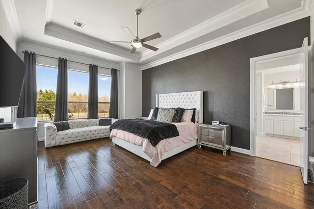 a spacious bedroom with a bed and large windows