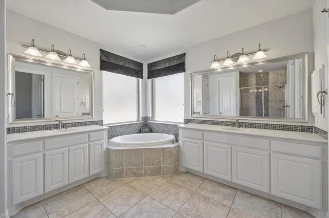 a bathroom with a double vanity sink and a mirror