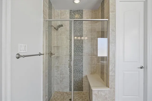 a bathroom with a glass shower door