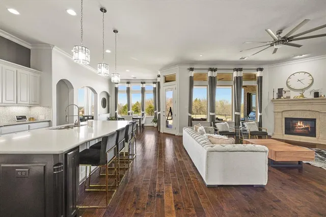 a living room with fireplace furniture and a large window