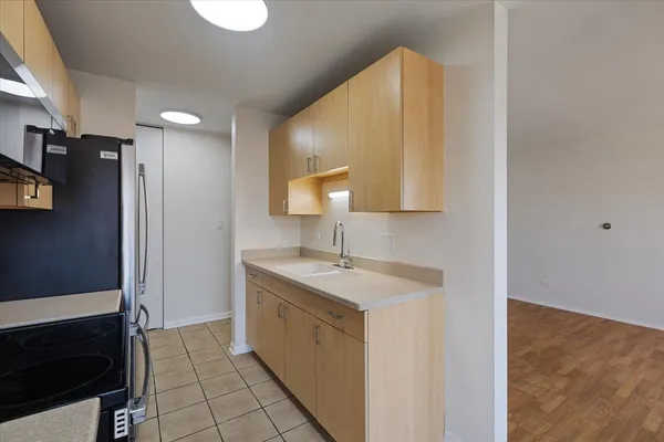a kitchen with a sink and a refrigerator