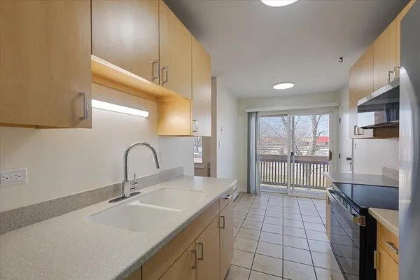 a kitchen with a sink and a refrigerator