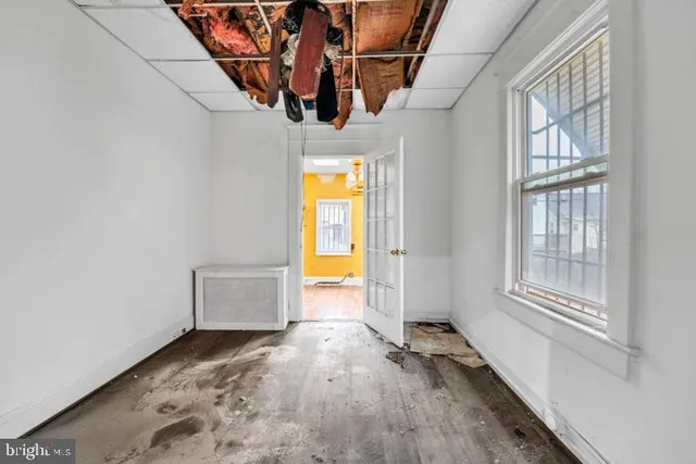 a view of a room with wooden floor and windows