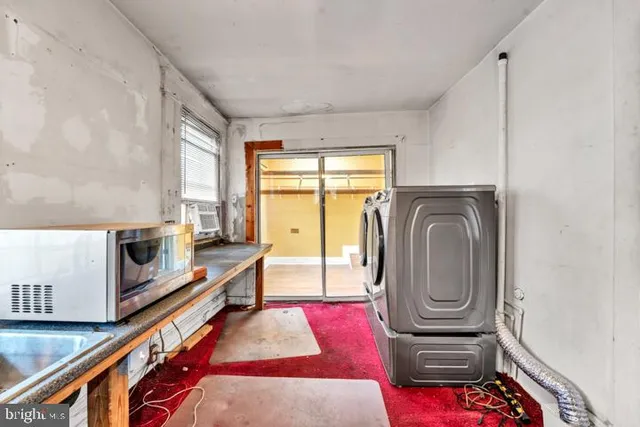a living room with furniture a flat screen tv and a dresser