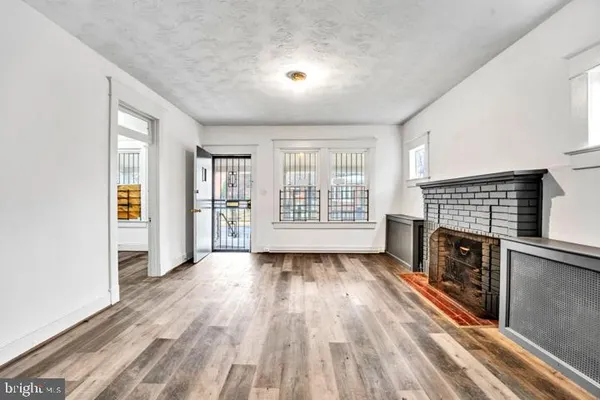 wooden floor in an empty room with a fireplace