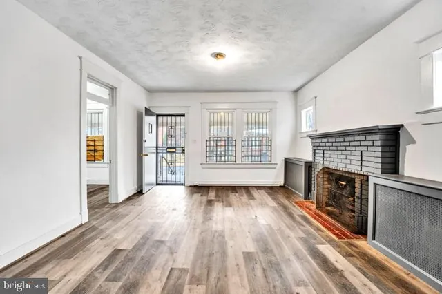 wooden floor in an empty room with a fireplace