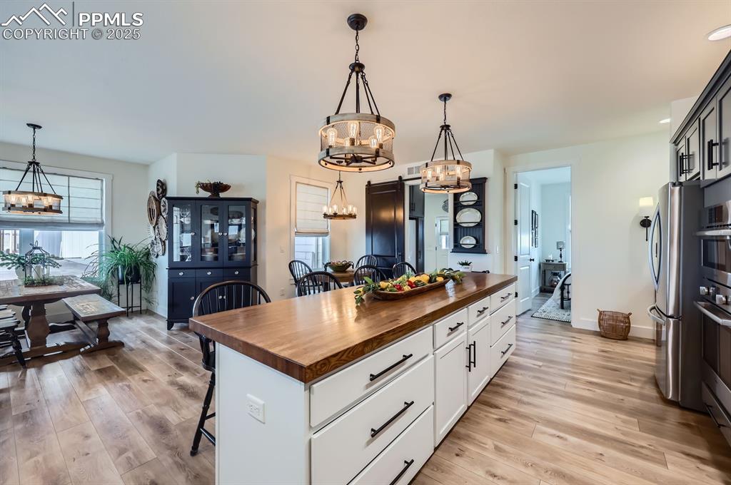 8735 Palomino Rdg View Peyton, CO 80831 - Photo 11 of 48 a large kitchen with sink a counter space and stainless steel appliances