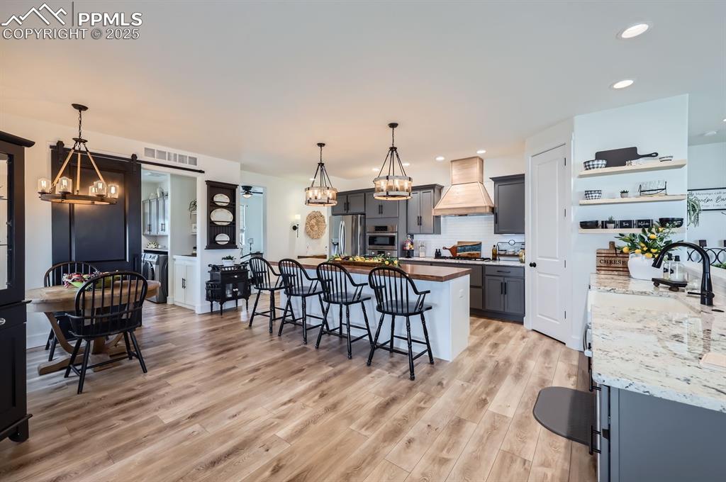 8735 Palomino Rdg View Peyton, CO 80831 - Photo 12 of 48 a view of a dining room with furniture and wooden floor