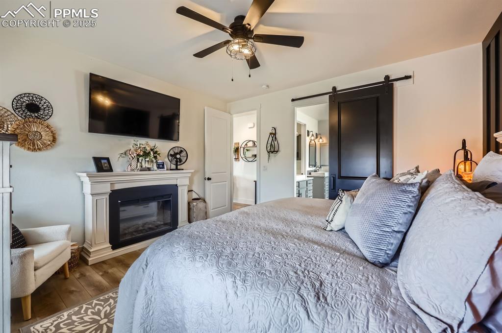 8735 Palomino Rdg View Peyton, CO 80831 - Photo 16 of 48 a bedroom with a bed and a flat screen tv