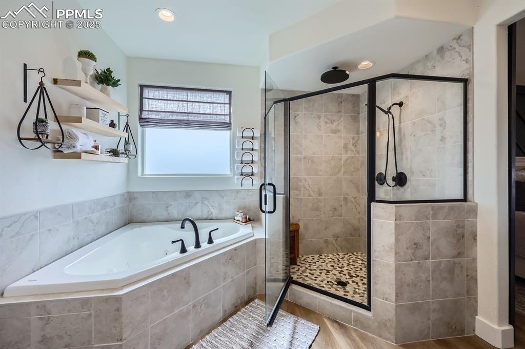 8735 Palomino Rdg View Peyton, CO 80831 - Photo 18 of 48 a bathroom with a bathtub and shower