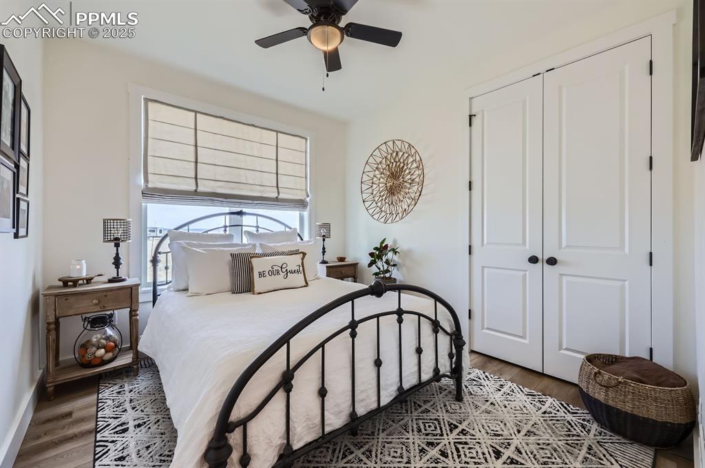 8735 Palomino Rdg View Peyton, CO 80831 - Photo 19 of 48 a bedroom with a bed a mirror and desk