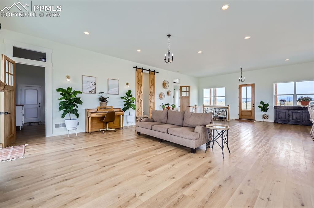 8735 Palomino Rdg View Peyton, CO 80831 - Photo 26 of 48 a living room with furniture and a wooden floor