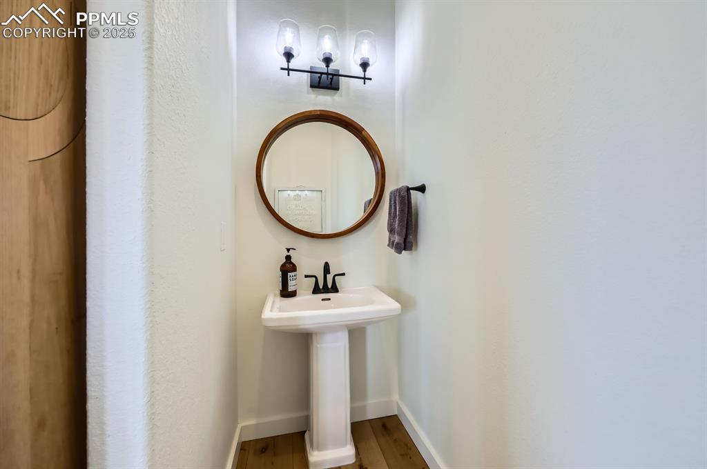 8735 Palomino Rdg View Peyton, CO 80831 - Photo 33 of 48 a bathroom with a sink a mirror and a shower