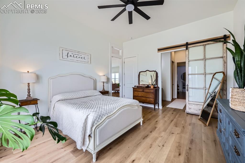 8735 Palomino Rdg View Peyton, CO 80831 - Photo 36 of 48 a bedroom with a bed a flat tv screen and dresser