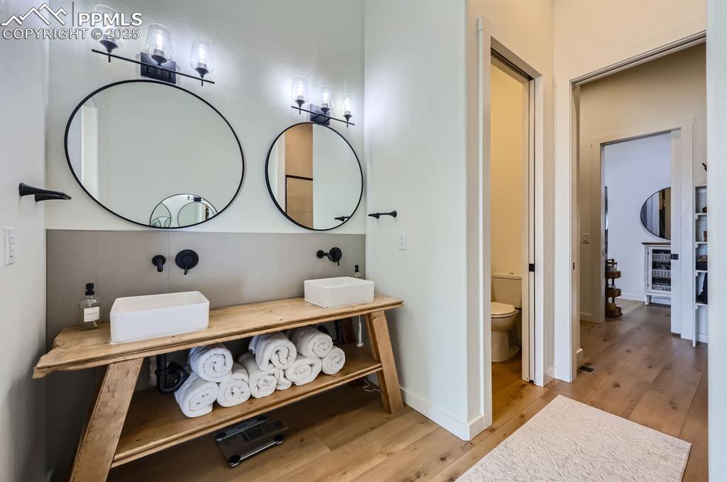8735 Palomino Rdg View Peyton, CO 80831 - Photo 37 of 48 a bathroom with a sink a vanity and a mirror