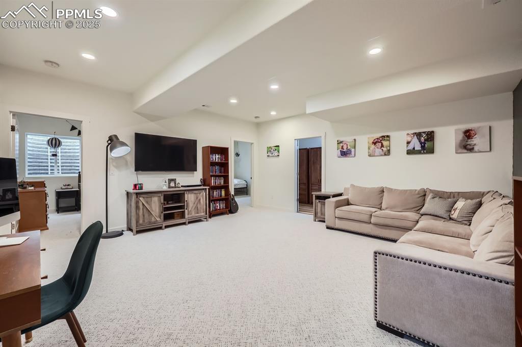 8735 Palomino Rdg View Peyton, CO 80831 - Photo 44 of 48 a living room with furniture and a flat screen tv
