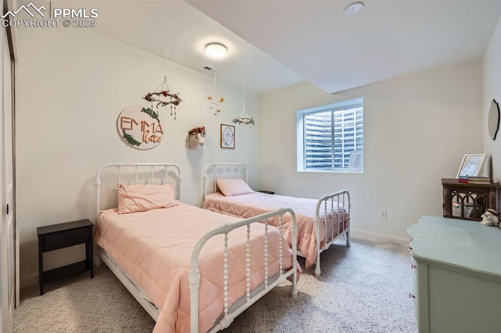 8735 Palomino Rdg View Peyton, CO 80831 - Photo 45 of 48 a bedroom with a bed and a desk