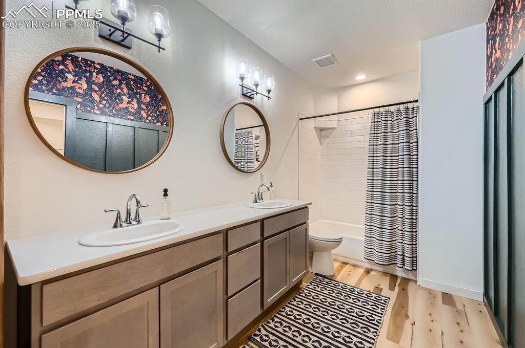 8735 Palomino Rdg View Peyton, CO 80831 - Photo 48 of 48 a bathroom with a double vanity sink mirror and toilet