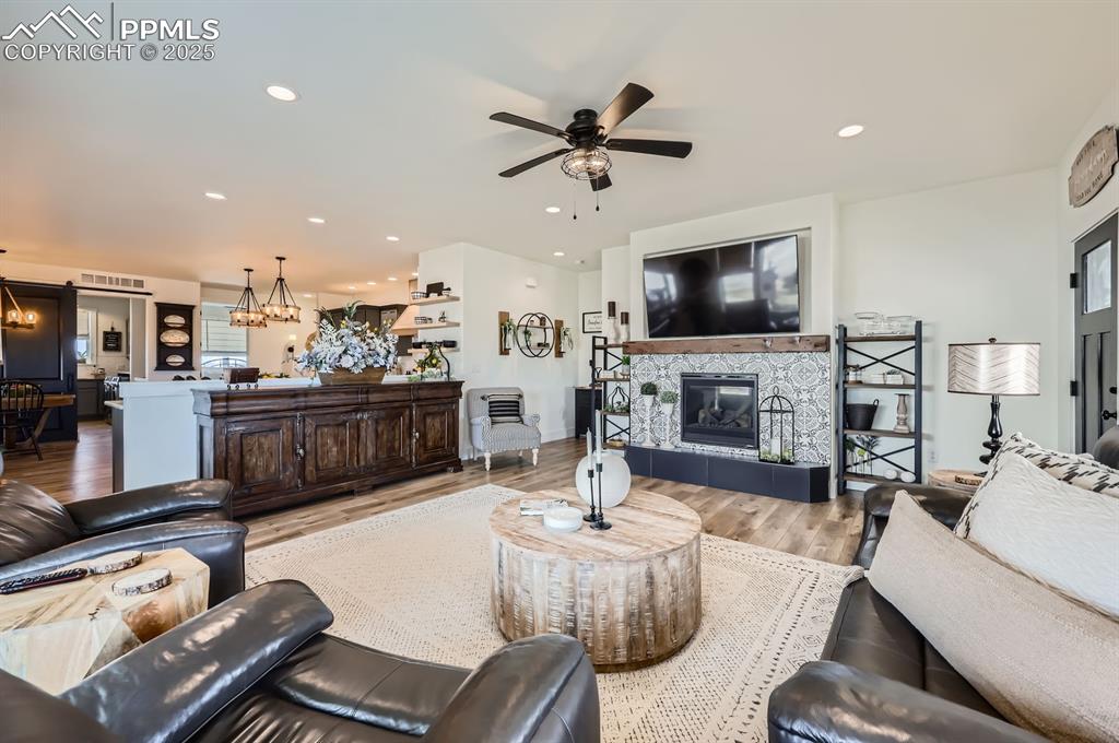 8735 Palomino Rdg View Peyton, CO 80831 - Photo 8 of 48 a living room with fireplace furniture and a flat screen tv