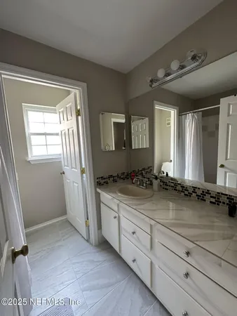 a bathroom with a granite countertop sink a mirror and a