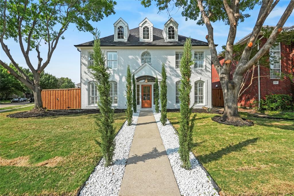 Colonial inspired home featuring brick siding